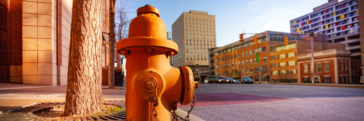 Close-up picture of orange fire hydrant on the sidewalk of Baltimore city, Maryland, USA