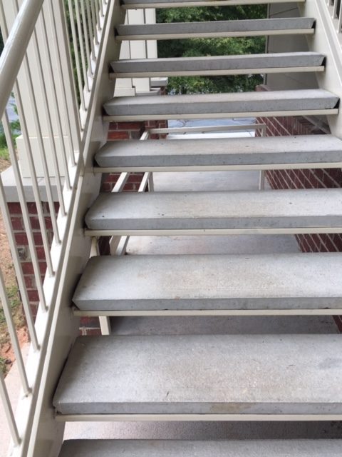 Concrete staircase with metal railing